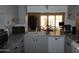 Kitchen featuring neutral cabinets, granite countertops, and a view into the living space at 409 S Mountain View Dr, Kearny, AZ 85137