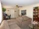 Comfortable living room featuring cozy couches and a view into the kitchen area at 409 S Mountain View Dr, Kearny, AZ 85137