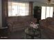 Cozy living room with comfortable couches and large windows for natural light at 409 S Mountain View Dr, Kearny, AZ 85137