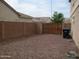 Gravel backyard features a block wall for privacy and a double gate providing access at 4253 E Colonial Dr, Chandler, AZ 85249