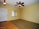 Bright living room featuring large windows and a ceiling fan, creating a comfortable and inviting atmosphere at 4253 E Colonial Dr, Chandler, AZ 85249