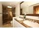 Elegant bathroom featuring double sinks and a shower with decorative brown tiling at 4621 N 65Th St # 152, Scottsdale, AZ 85251