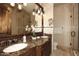 Well-lit bathroom featuring double sinks with granite countertops and glass-enclosed shower at 4621 N 65Th St # 152, Scottsdale, AZ 85251