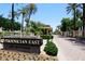 Community entrance sign amongst mature landscaping and palm trees at 4621 N 65Th St # 152, Scottsdale, AZ 85251