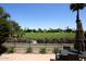 Scenic golf course view from the home's patio, framed by lush landscaping and blue skies at 4621 N 65Th St # 152, Scottsdale, AZ 85251