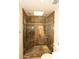 Luxurious tile shower boasts glass door, seating and inset shelving for bathroom necessities at 4621 N 65Th St # 152, Scottsdale, AZ 85251