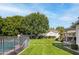 Backyard with a pool, large trees, grass and a view of the home's exterior at 4826 N 34Th Pl, Phoenix, AZ 85018