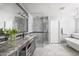 Elegant bathroom featuring double sinks, a glass-enclosed shower, and a freestanding bathtub at 4826 N 34Th Pl, Phoenix, AZ 85018