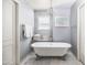 Charming bathroom with a clawfoot tub, chandelier, and ample natural light at 4826 N 34Th Pl, Phoenix, AZ 85018