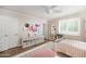 Bedroom with hard wood floors, white storage bench, and a view of the entry door at 4826 N 34Th Pl, Phoenix, AZ 85018