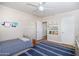 Cozy bedroom featuring a striped area rug, built in shelving and a comfortable bed at 4826 N 34Th Pl, Phoenix, AZ 85018