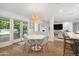 Bright dining room with a decorative light fixture, breakfast bar, and easy access to outdoor patio at 4826 N 34Th Pl, Phoenix, AZ 85018