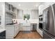 Updated kitchen with stainless steel appliances, white cabinets, and a charming farmhouse sink at 4826 N 34Th Pl, Phoenix, AZ 85018