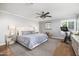 Spacious main bedroom featuring a comfortable bed, a ceiling fan, and bright window light at 4826 N 34Th Pl, Phoenix, AZ 85018