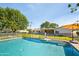 Inviting backyard pool with safety fence and lush landscaping, perfect for outdoor relaxation and entertainment at 4826 N 34Th Pl, Phoenix, AZ 85018