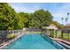 Refreshing backyard pool surrounded by mature trees and a secure safety fence for Gathering enjoyment at 4826 N 34Th Pl, Phoenix, AZ 85018