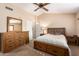 Spacious bedroom with ceiling fan and a large dresser complemented by a king-size bed at 500 N Roosevelt Ave # 118, Chandler, AZ 85226