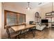 Dining area featuring a wood table, chairs, tile flooring, neutral walls, and decorative lighting at 500 N Roosevelt Ave # 118, Chandler, AZ 85226