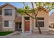 Inviting two-story townhome with a red tile roof and mature tree in front of the entrance at 500 N Roosevelt Ave # 118, Chandler, AZ 85226