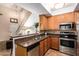 Functional kitchen featuring wooden cabinets, stainless steel appliances, and tile backsplash at 500 N Roosevelt Ave # 118, Chandler, AZ 85226