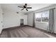 Bright bedroom features a ceiling fan, neutral carpet, closet, and a large window with city views at 5106 N 17Th Ave # 11, Phoenix, AZ 85015