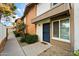 Charming townhome featuring a blue security door and well-maintained landscaping with gravel and a tidy walkway at 5106 N 17Th Ave # 11, Phoenix, AZ 85015