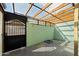 Enclosed patio showing secure metal gate and adjacent green block wall at 5106 N 17Th Ave # 11, Phoenix, AZ 85015