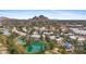 Stunning aerial view of Scottsdale community, featuring a pond, mature trees, and Camelback Mountain in the distance at 5132 N 31St Way # 144, Phoenix, AZ 85016