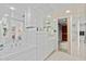 Bright bathroom featuring white cabinets, tile countertops, and a mirrored wall at 5132 N 31St Way # 144, Phoenix, AZ 85016