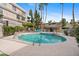 Community pool and spa area with seating and lush landscaping at 5132 N 31St Way # 144, Phoenix, AZ 85016