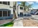 Exterior view of a two-story condo with stairwell access and manicured landscaping at 600 W Grove Pkwy # 2188, Tempe, AZ 85283