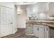 Kitchen featuring grey cabinetry, stainless steel sink, and hardwood flooring at 600 W Grove Pkwy # 2188, Tempe, AZ 85283