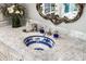 Close up shot of a elegant bathroom vanity with marble countertop and blue floral sink at 6221 E Vista Dr, Paradise Valley, AZ 85253