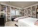 This bedroom features unique bookshelf wallpaper, plantation shutters, and comfortable furnishings at 6221 E Vista Dr, Paradise Valley, AZ 85253