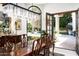 Formal dining room with stylish light fixture and view of the tranquil backyard and fountain at 6221 E Vista Dr, Paradise Valley, AZ 85253