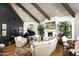 Another view of this elegant living room with vaulted ceilings, cozy fireplace, grand piano, and luxurious seating at 6221 E Vista Dr, Paradise Valley, AZ 85253