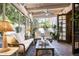 Relaxing screened porch with white furniture, a ceiling fan, and a view of the tranquil backyard at 6221 E Vista Dr, Paradise Valley, AZ 85253