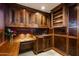 Sophisticated wet bar featuring rich wood cabinetry, ample storage, sink, mini-fridge, and counter space at 6221 E Vista Dr, Paradise Valley, AZ 85253