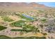 Aerial view of a golf course and clubhouse nestled amidst desert landscaping with mountain views at 7442 E Golden Eagle Cir, Gold Canyon, AZ 85118