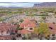 Aerial view of desert homes with terracotta tile roofs surrounded by desert landscaping and golf course at 7442 E Golden Eagle Cir, Gold Canyon, AZ 85118