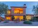 Back of the home with desert landscaping, a balcony and outdoor lighting at 7442 E Golden Eagle Cir, Gold Canyon, AZ 85118