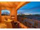 Outdoor balcony boasting desert views, a fireplace, and plush seating, perfect for evening relaxation at 7442 E Golden Eagle Cir, Gold Canyon, AZ 85118