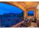 Relaxing balcony with wrought iron railing overlooking the landscape, cozy seating, and ample natural light at 7442 E Golden Eagle Cir, Gold Canyon, AZ 85118