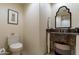 Stylish powder room with unique vanity, marble countertop, and elegant mirror at 7442 E Golden Eagle Cir, Gold Canyon, AZ 85118