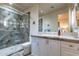 Well-lit bathroom with tiled shower, vanity with cabinets, and modern fixtures at 7442 E Golden Eagle Cir, Gold Canyon, AZ 85118