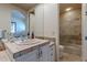 Bathroom vanity with stone counters, white cabinetry, and a shower in view at 7442 E Golden Eagle Cir, Gold Canyon, AZ 85118