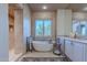 Luxury bathroom featuring standalone tub, tiled shower and large windows at 7442 E Golden Eagle Cir, Gold Canyon, AZ 85118