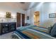 Bedroom with an accent cabinet, a queen bed, and window-filled natural light at 7442 E Golden Eagle Cir, Gold Canyon, AZ 85118