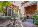 Charming courtyard with stone fountain, bougainvillea, comfortable seating and potted plants at 7442 E Golden Eagle Cir, Gold Canyon, AZ 85118