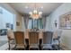 Formal dining room featuring a large window, elegant chandelier, and seating for eight at 7442 E Golden Eagle Cir, Gold Canyon, AZ 85118